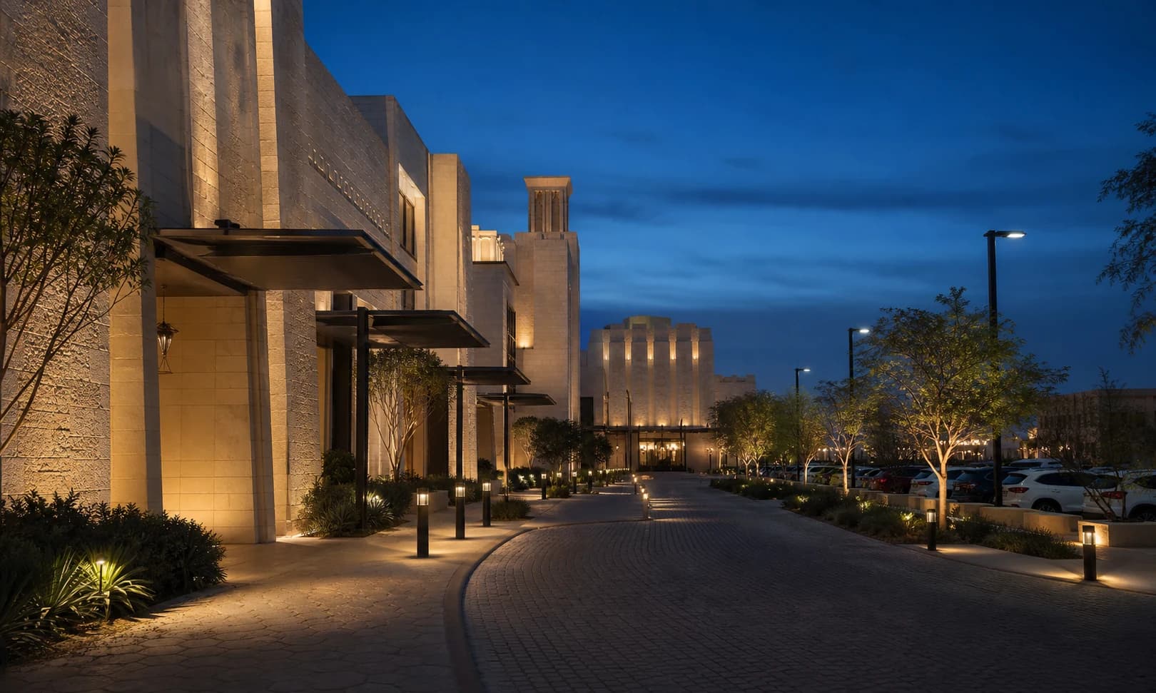 Middle East public-realm arrival route with facade, landscape and pedestrian lighting