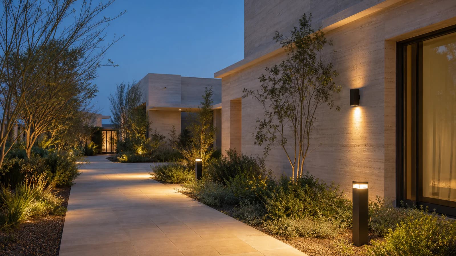 Illustrative bollard and wall lighting along a landscaped villa path