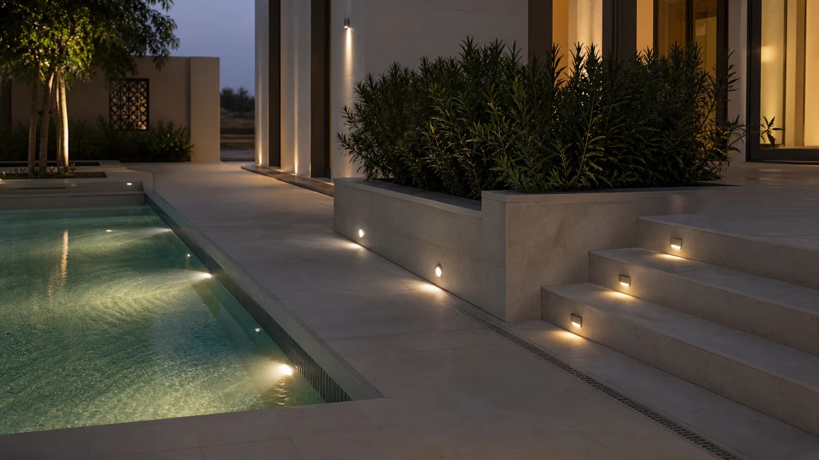 Illustrative in-ground, step and underwater lighting beside a villa pool